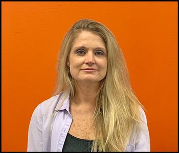 Female employee with an orange background