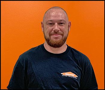 Male employee with an orange background