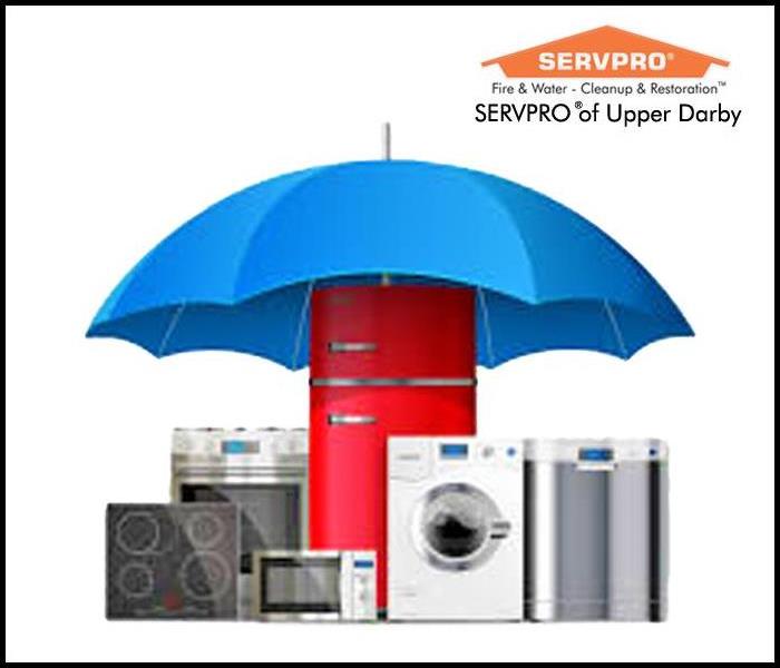 Several appliances sit under a blue umbrella