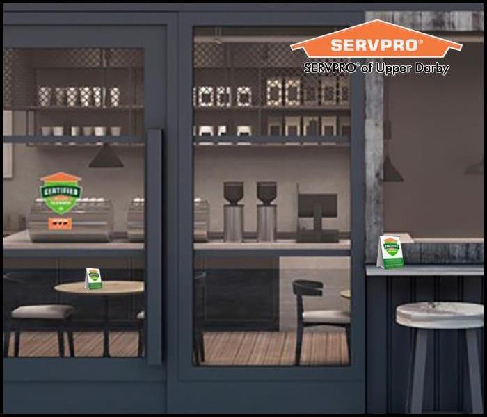An empty cafe with Certified: Servpro Clean signage