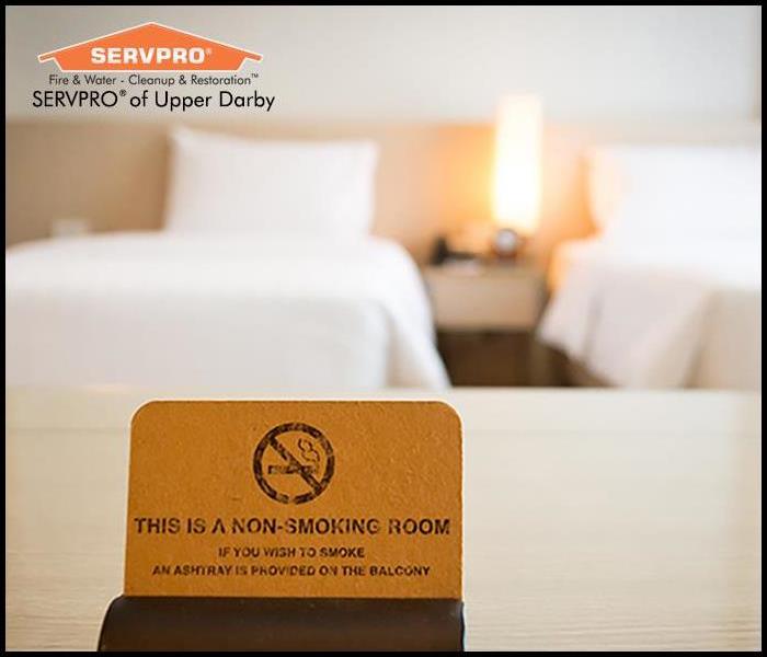 Non smoking sign on a hotel room bed